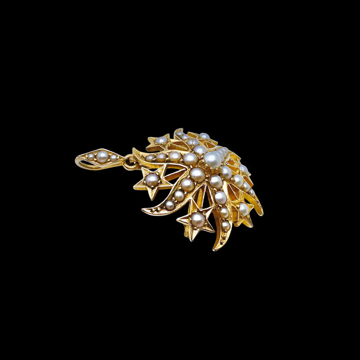 Three-quarter view of antique Victorian split pearl starburst pendant and brooch in 15ct gold, highlighting depth, pearl settings and celestial starburst form