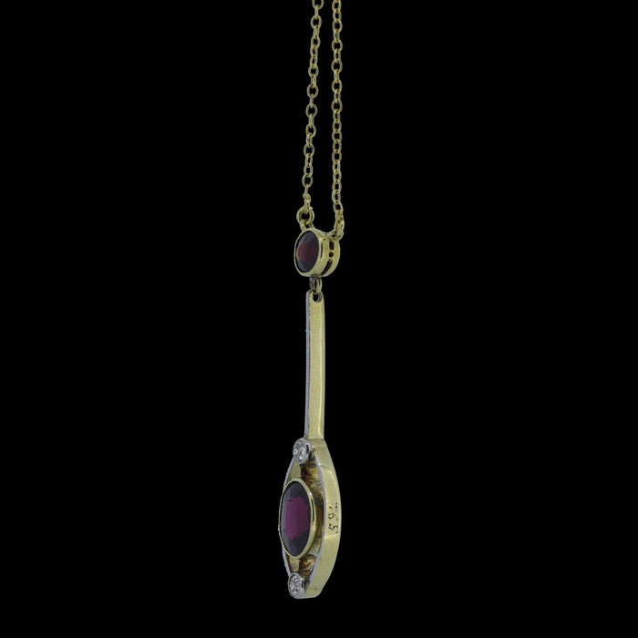 3/4 shot of Edwardian 15ct gold garnet and diamond drop necklace showing open-backed settings