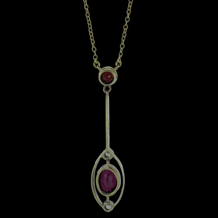 Reverse of Edwardian 15ct gold garnet and diamond drop necklace showing open-backed settings